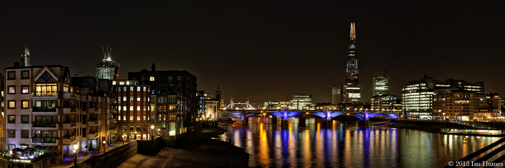 The Shard, Tower Bridge and the `Walkie Talkie` building photographed from the Millennium Bridge at night - London